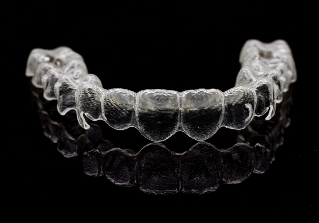 Clear aligner trays on a black background