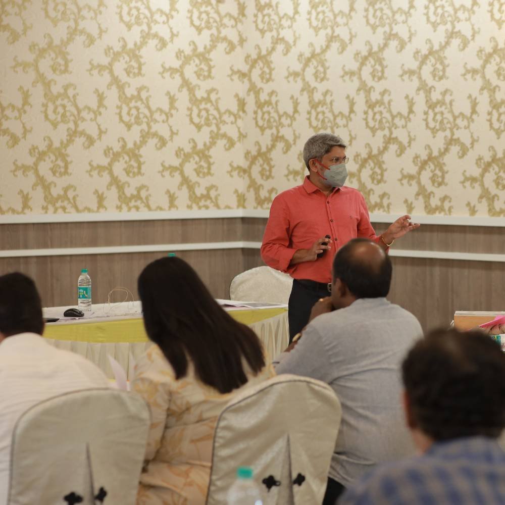 A trainer lecturing to dentists at the workshop